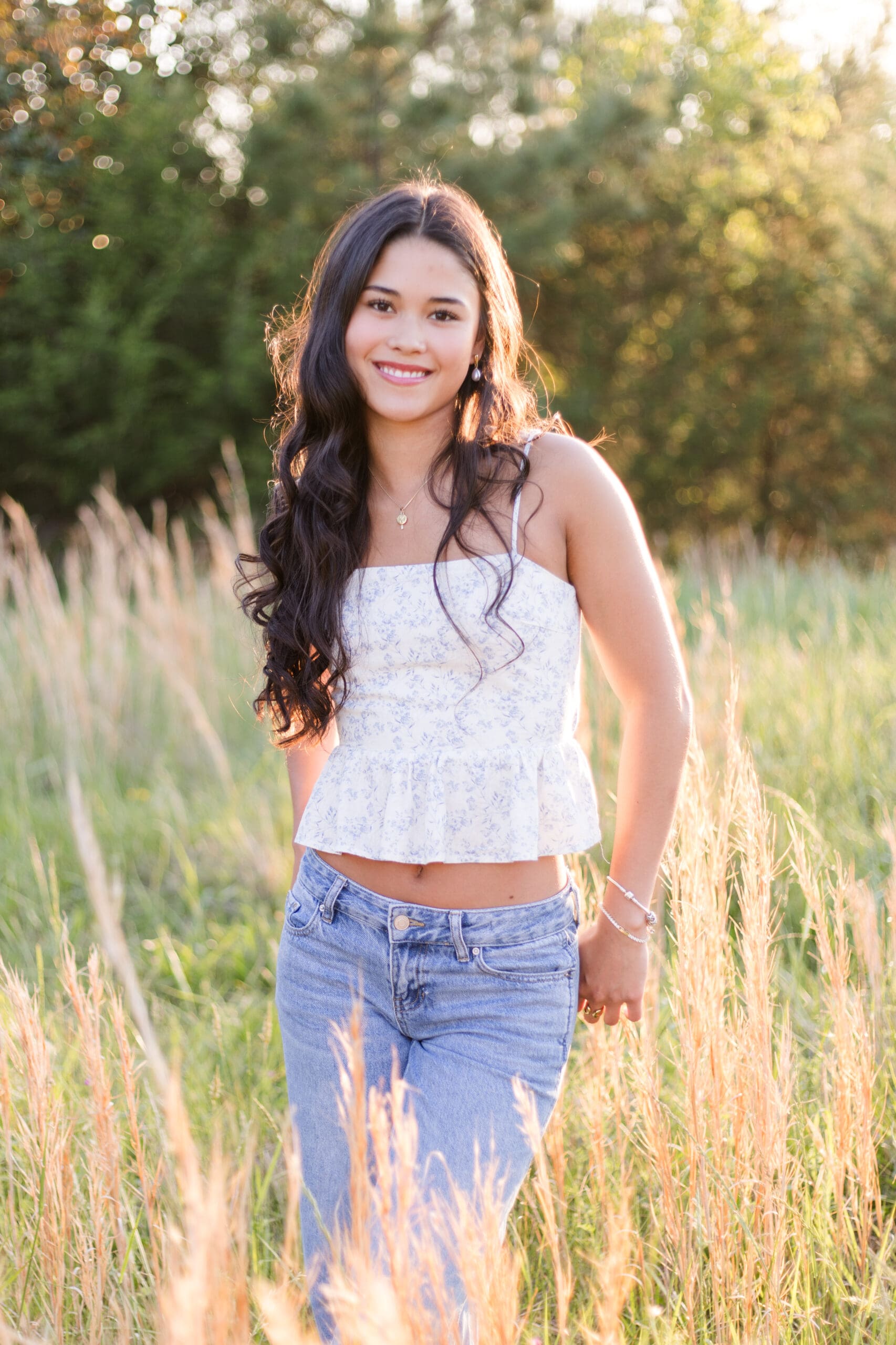 Sydney poses casually in a field of tall grass in Davidson, NC